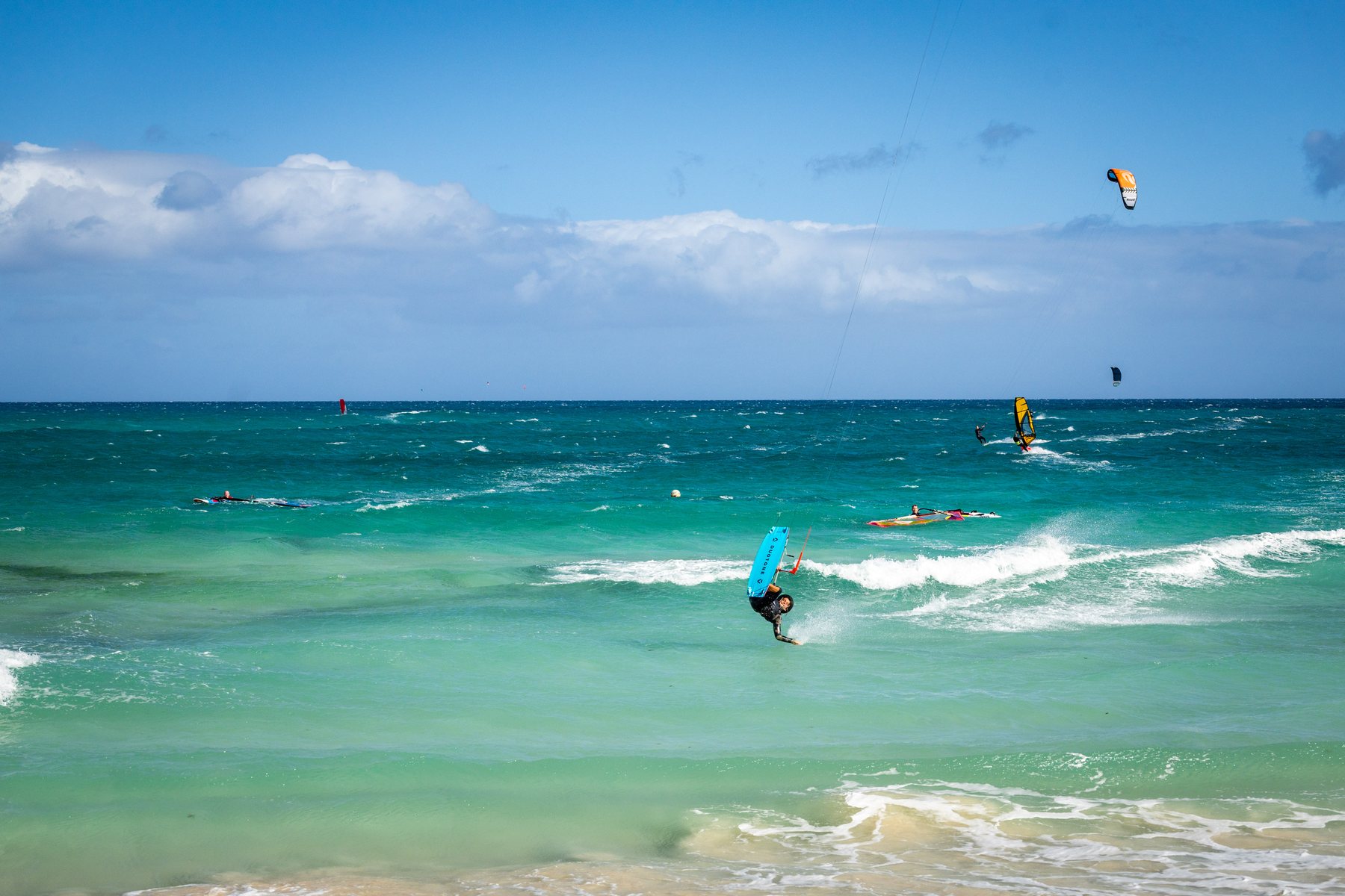 Kitesurfing in turquoise water in Fuerteventura